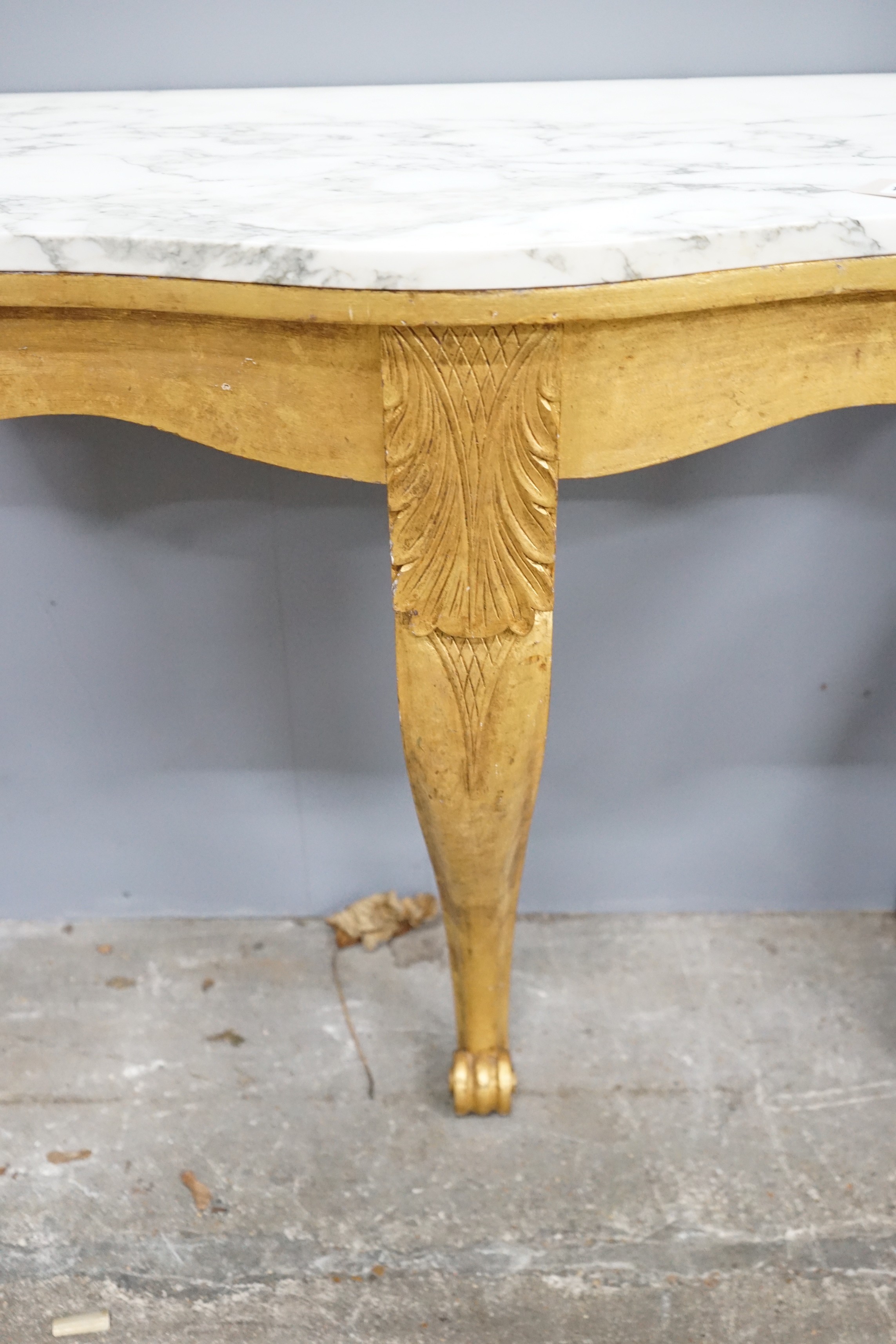 A pair of Victorian style marble topped serpentine giltwood console tables, width 84cm, depth 44cm, height 79cm